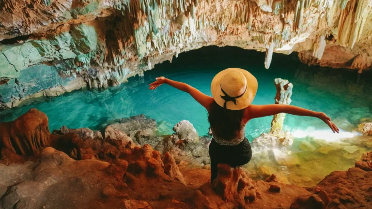 A photo of a person swimming in the blue-water pool of Rangko Cave