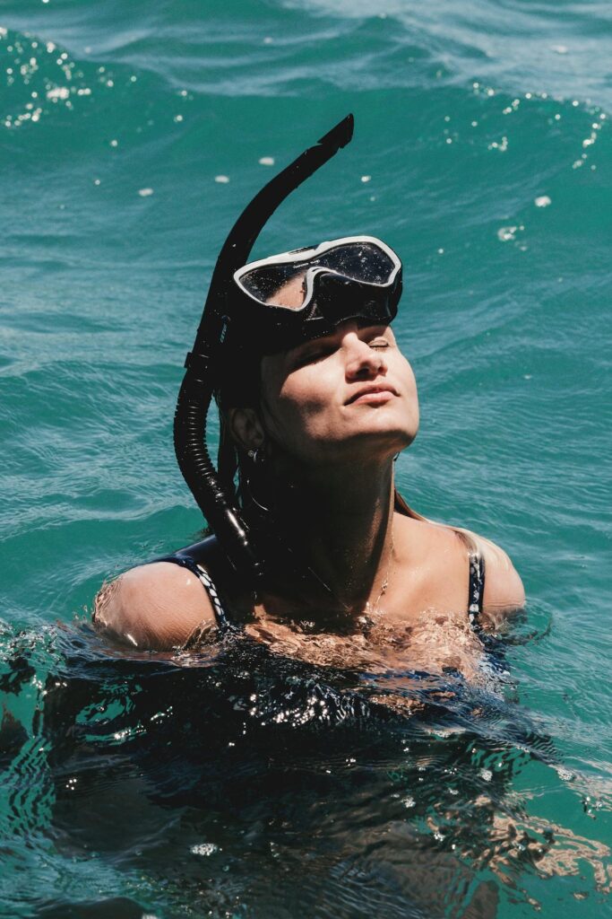 A photo of a snorkeler looking at a sea turtle